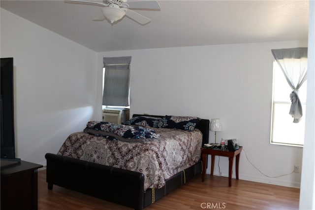 bedroom with ceiling fan and wood-type flooring