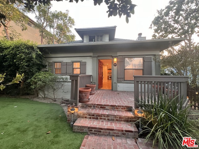 back of house with a lawn