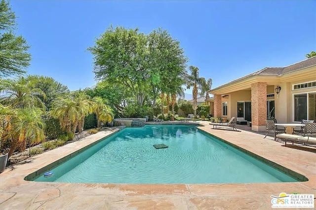 view of swimming pool with a patio area