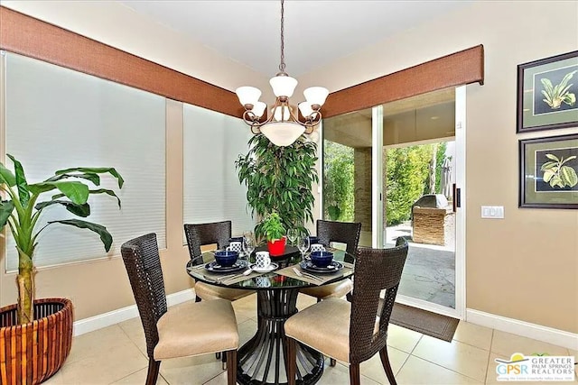 dining room featuring light tile patterned flooring and a chandelier