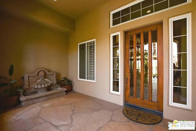 doorway to property featuring a patio area