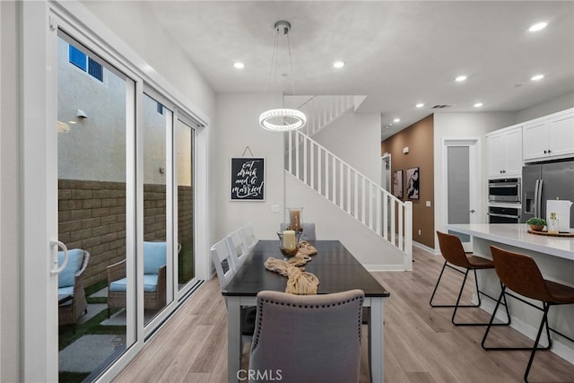 dining space featuring light wood-type flooring