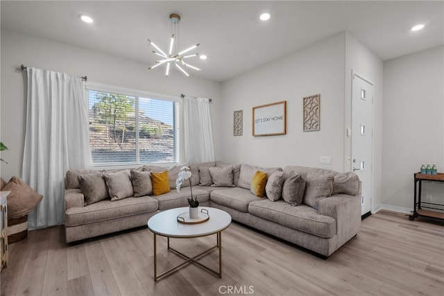 living room featuring an inviting chandelier and light wood-type flooring