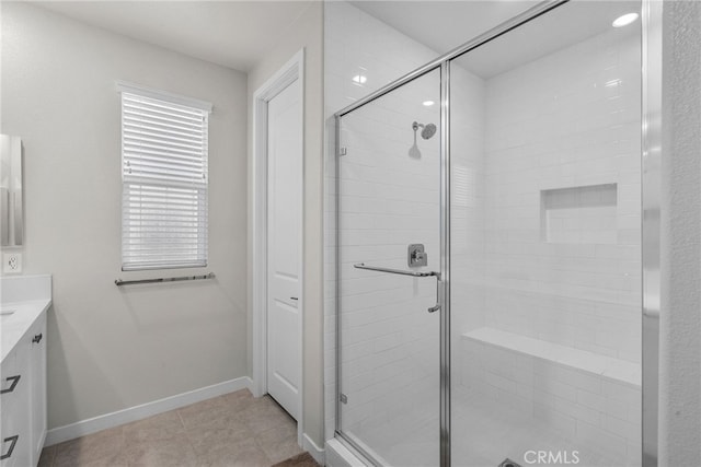 bathroom with vanity, tile patterned floors, and a shower with shower door