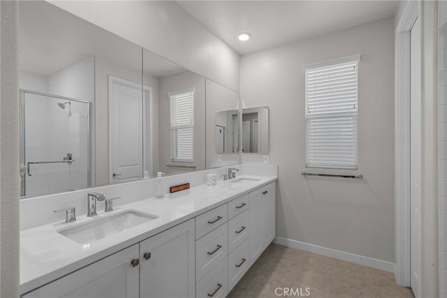 bathroom featuring tile patterned flooring, vanity, and a shower with door