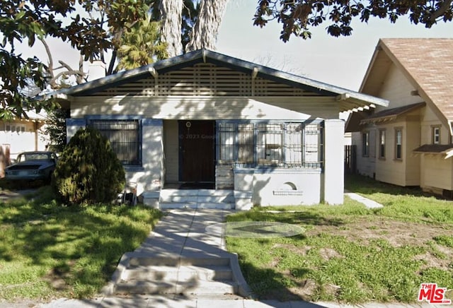 bungalow with a front yard