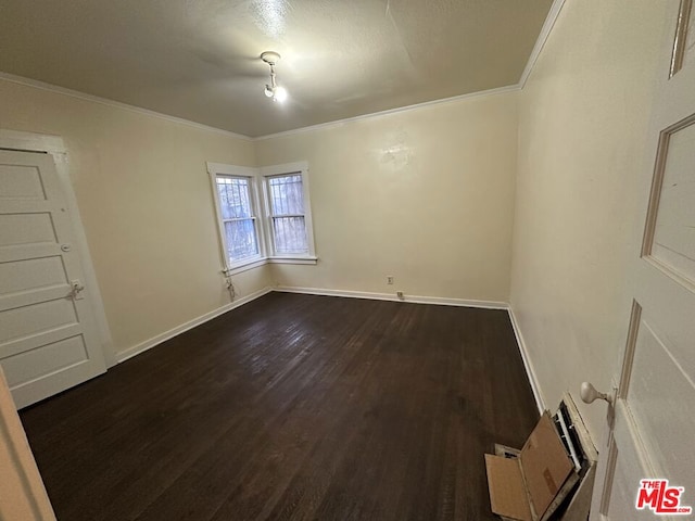 unfurnished room featuring wood-type flooring and ornamental molding