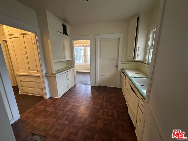 kitchen featuring sink and white cabinets