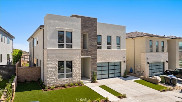 view of front of property featuring a garage and a front lawn