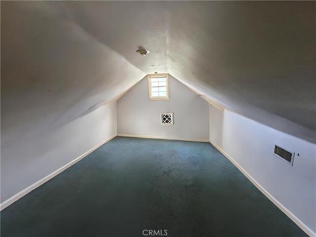 bonus room with carpet flooring and vaulted ceiling