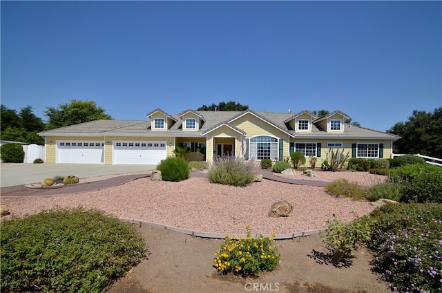 cape cod home featuring a garage