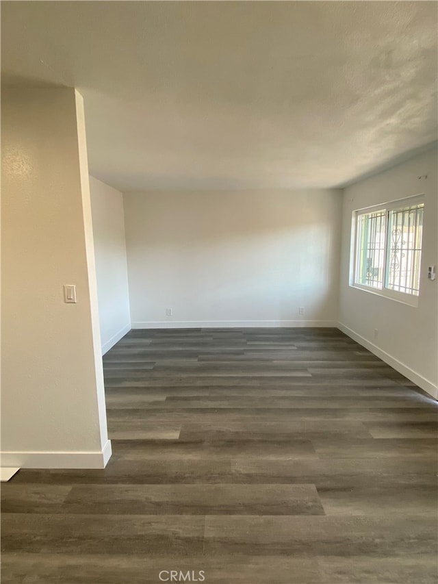 unfurnished room featuring dark hardwood / wood-style flooring