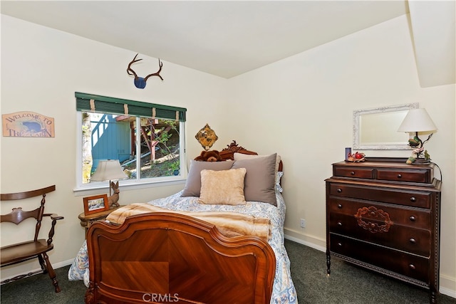 bedroom featuring dark colored carpet