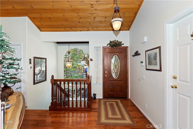 entrance foyer featuring dark wood-type flooring and wood ceiling