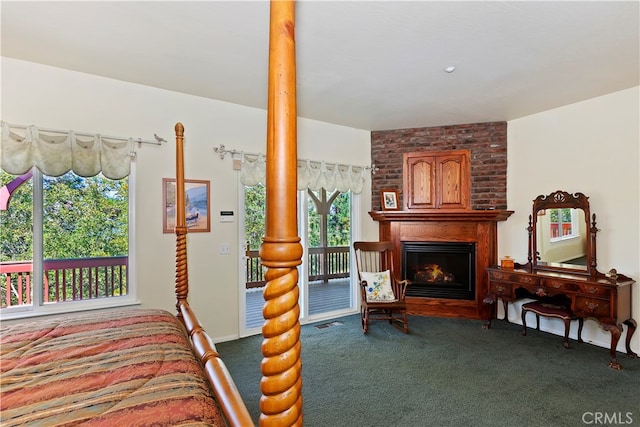 carpeted bedroom with a brick fireplace