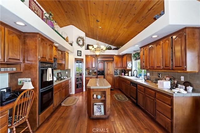 kitchen featuring a kitchen island, dark wood-type flooring, hanging light fixtures, sink, and black appliances