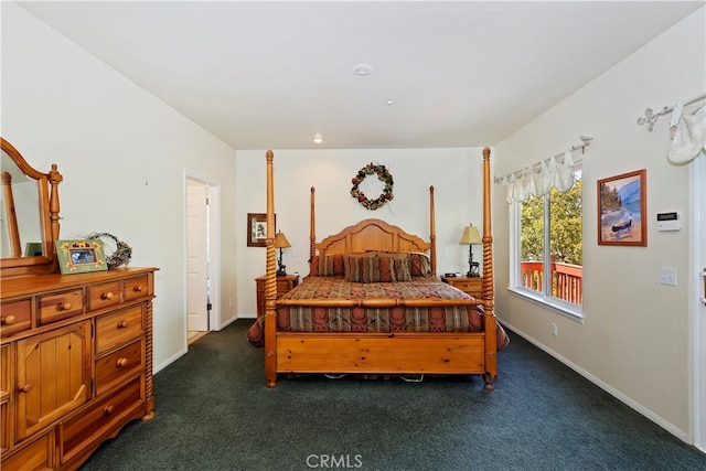 bedroom featuring dark colored carpet