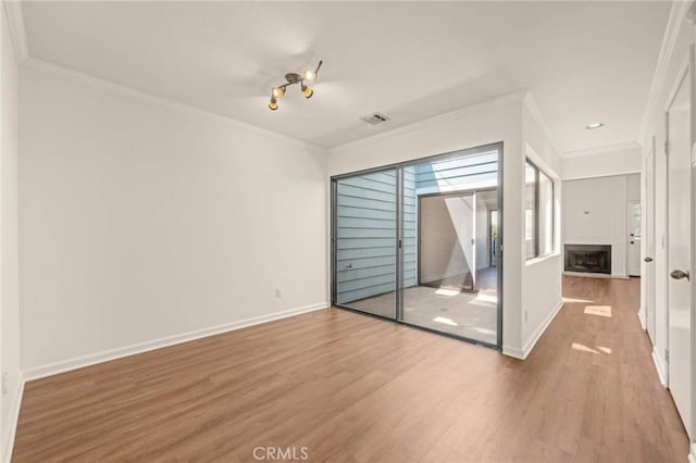 interior space featuring hardwood / wood-style floors and crown molding