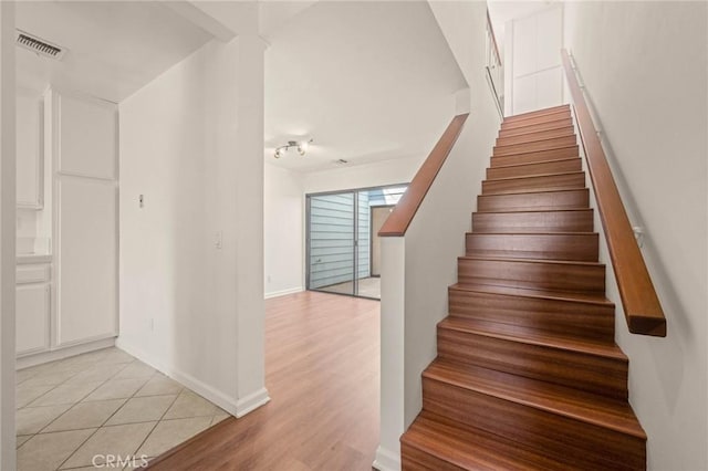 staircase with hardwood / wood-style floors