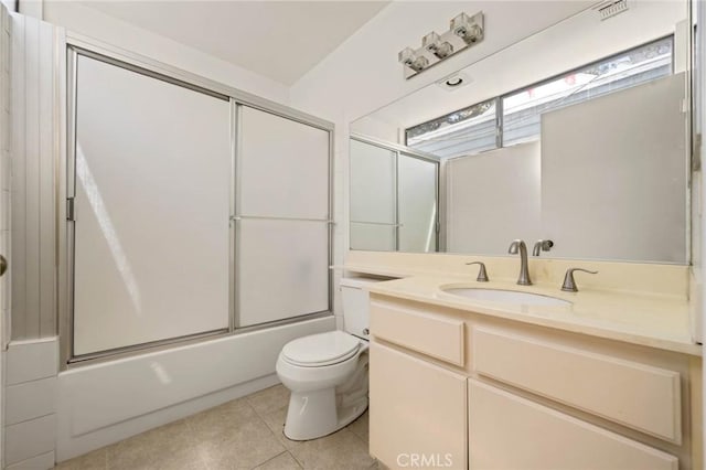 full bathroom with tile patterned flooring, vanity, bath / shower combo with glass door, and toilet