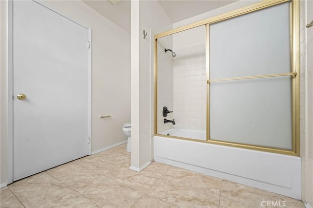 bathroom featuring tile patterned flooring, toilet, and enclosed tub / shower combo