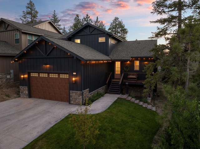 view of front facade featuring a yard, a deck, and a garage