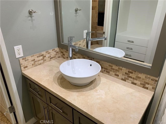 bathroom featuring vanity and backsplash