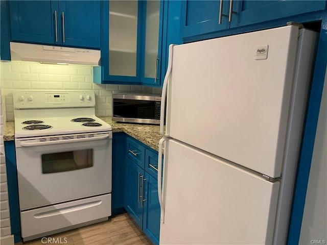 kitchen featuring blue cabinetry, white appliances, light hardwood / wood-style flooring, and light stone counters