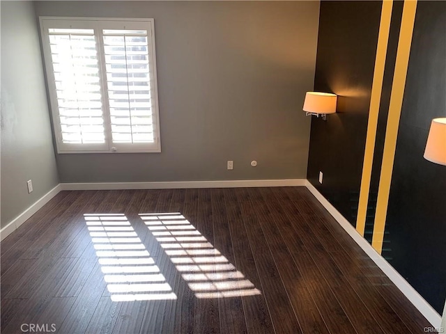 unfurnished room featuring dark wood-type flooring