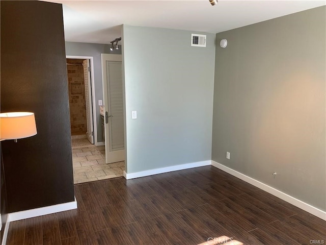 spare room with dark wood-type flooring