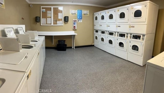 clothes washing area featuring washing machine and dryer, stacked washer / drying machine, and ornamental molding