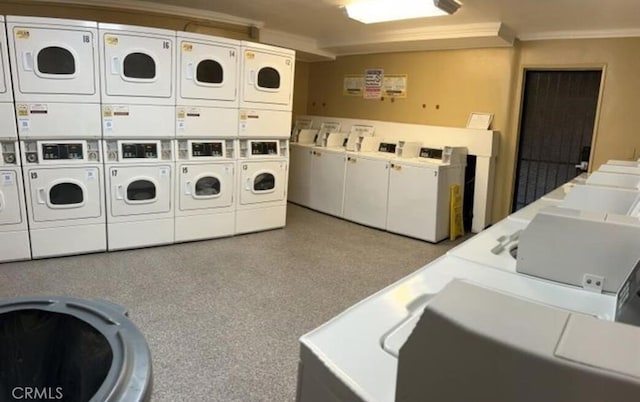 laundry room featuring stacked washer and dryer, washer and clothes dryer, and ornamental molding