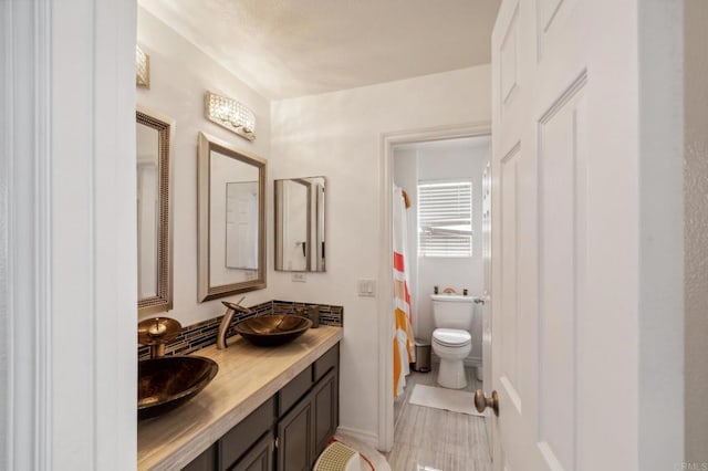 bathroom featuring vanity, toilet, tile patterned floors, and a shower with curtain