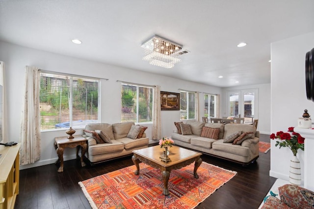 living room featuring a chandelier and dark hardwood / wood-style flooring