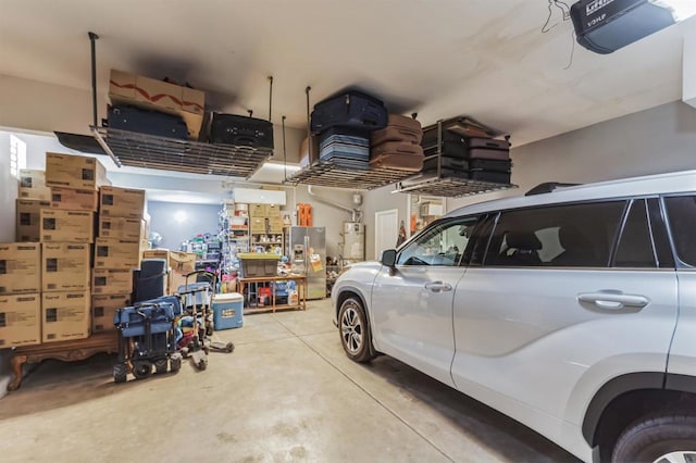 garage featuring a garage door opener, stainless steel fridge with ice dispenser, and water heater