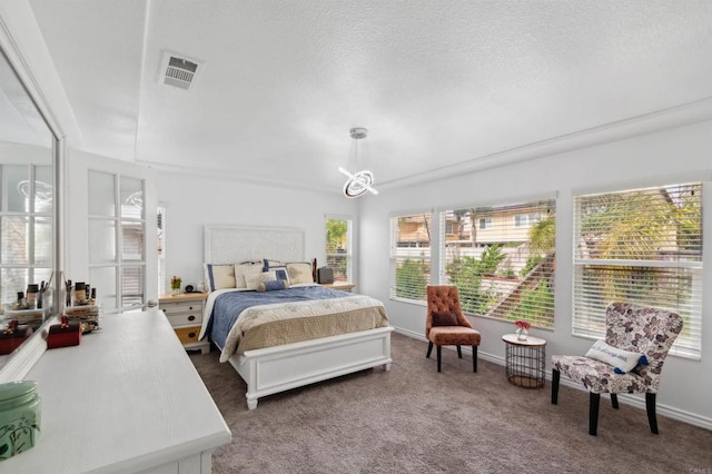 carpeted bedroom featuring a textured ceiling