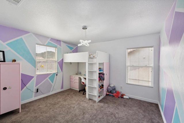 carpeted bedroom with a textured ceiling