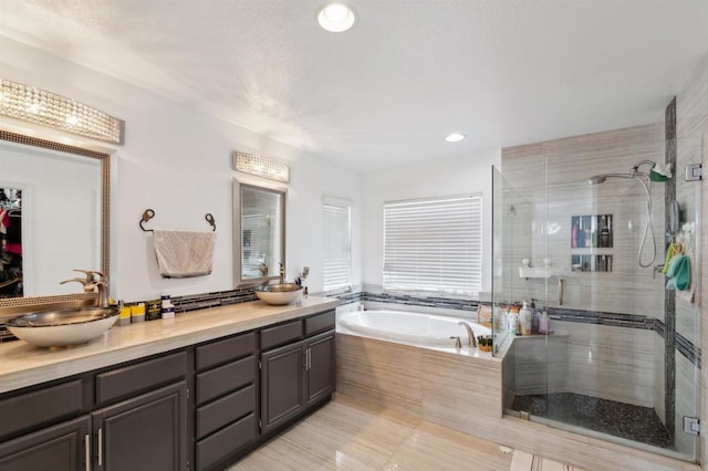 bathroom featuring vanity, tile patterned floors, and separate shower and tub