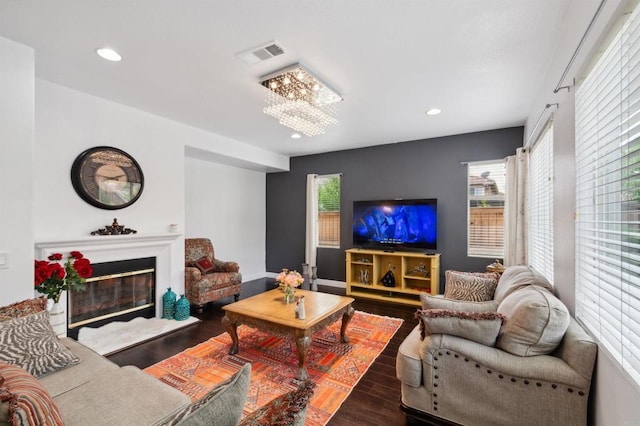 living room featuring dark hardwood / wood-style floors and an inviting chandelier