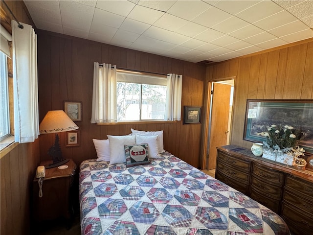 bedroom with wood walls