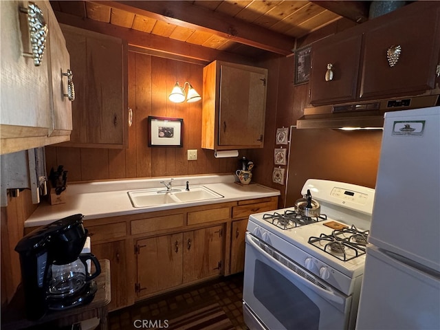 kitchen featuring sink, beamed ceiling, wooden ceiling, and white appliances