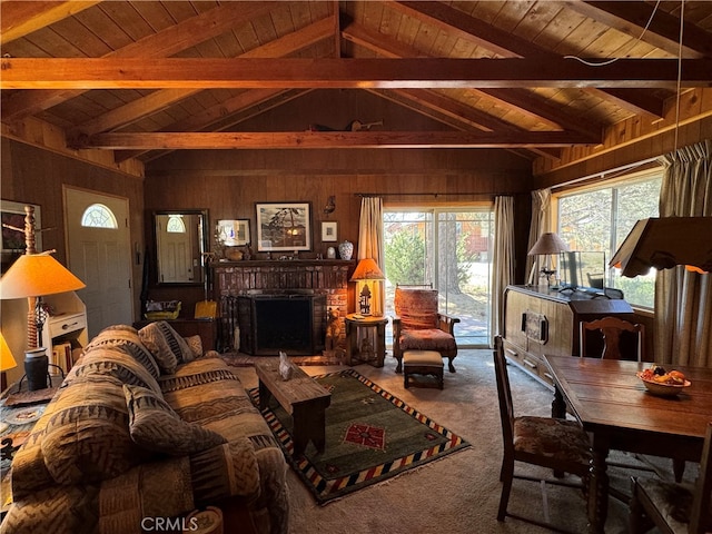 carpeted living room featuring wood walls, lofted ceiling with beams, a brick fireplace, and wood ceiling