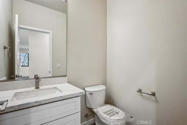 bathroom with toilet and vanity