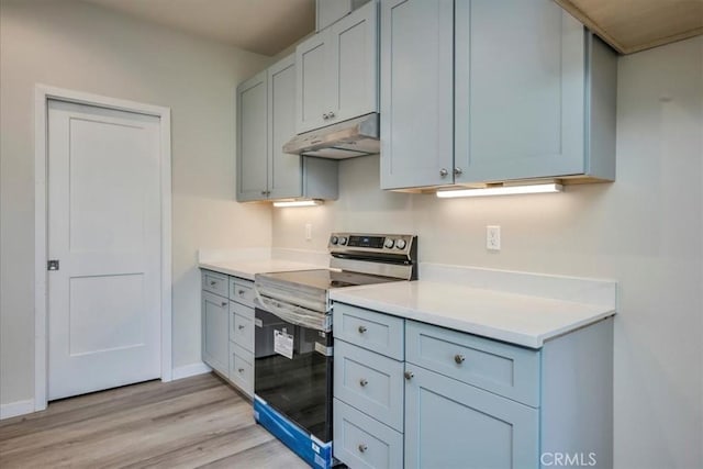 kitchen with stainless steel range with electric stovetop and light hardwood / wood-style flooring