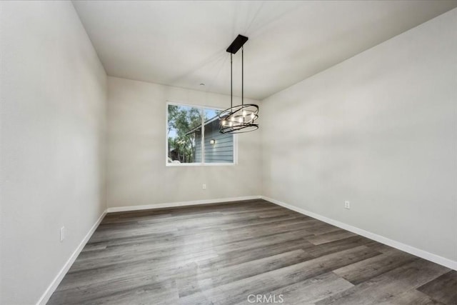 unfurnished dining area with dark wood-type flooring