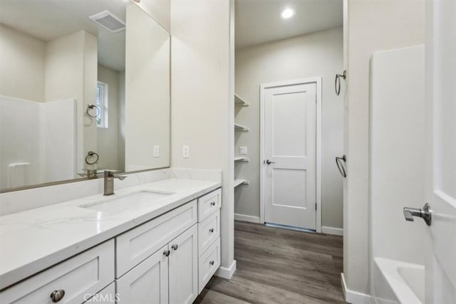 bathroom featuring vanity,  shower combination, and hardwood / wood-style floors