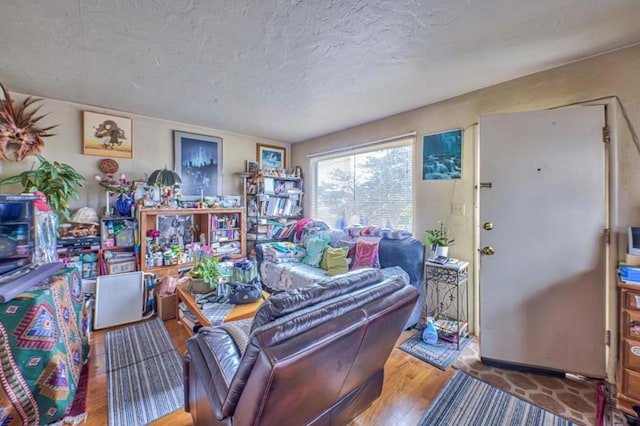 living room with hardwood / wood-style floors and a textured ceiling