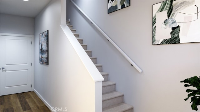 stairs featuring hardwood / wood-style flooring