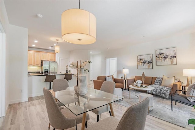 dining space featuring light wood-type flooring