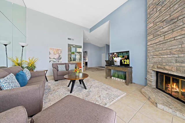 living room with light tile patterned flooring, a brick fireplace, and high vaulted ceiling